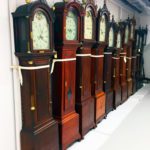 dark wood vintage and historic clocks on art rack